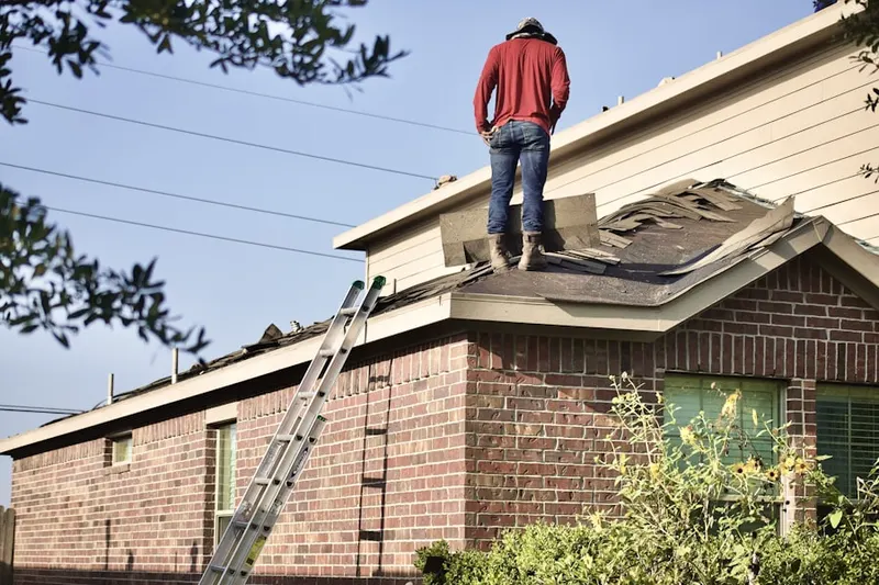 Professional roofer working on a residential roof in Remsterville